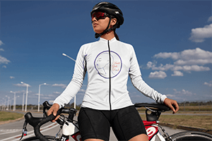 long-sleeve-cycling-jersey-mockup-featuring-a-woman-posing-by-her-bike-30782