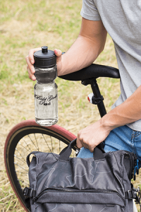 mockup-of-a-water-bottle-in-the-hand-of-a-man-sitting-on-his-bike-24431